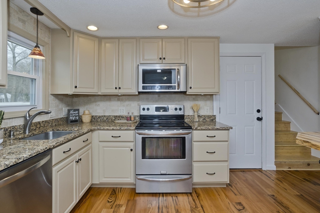 76 Paulk Terrace Springfield, MA 01128 - Photo 8 of 26 a kitchen with stainless steel appliances granite countertop a stove a sink and a microwave
