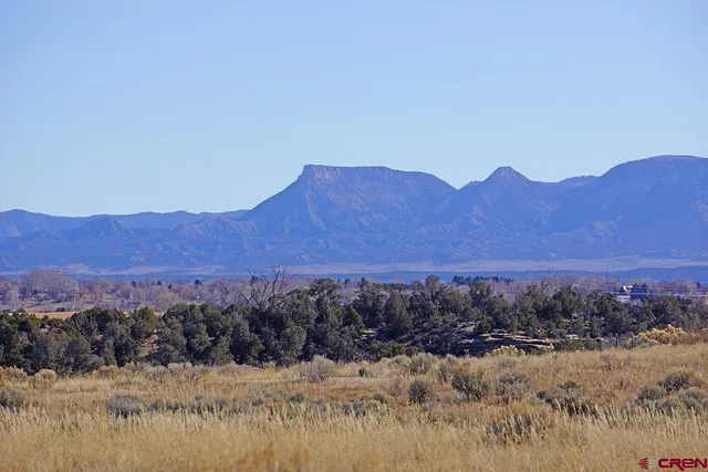 a view of mountain with sunset in background