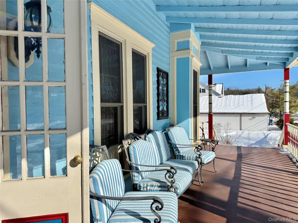 a view of balcony and dining area with furniture