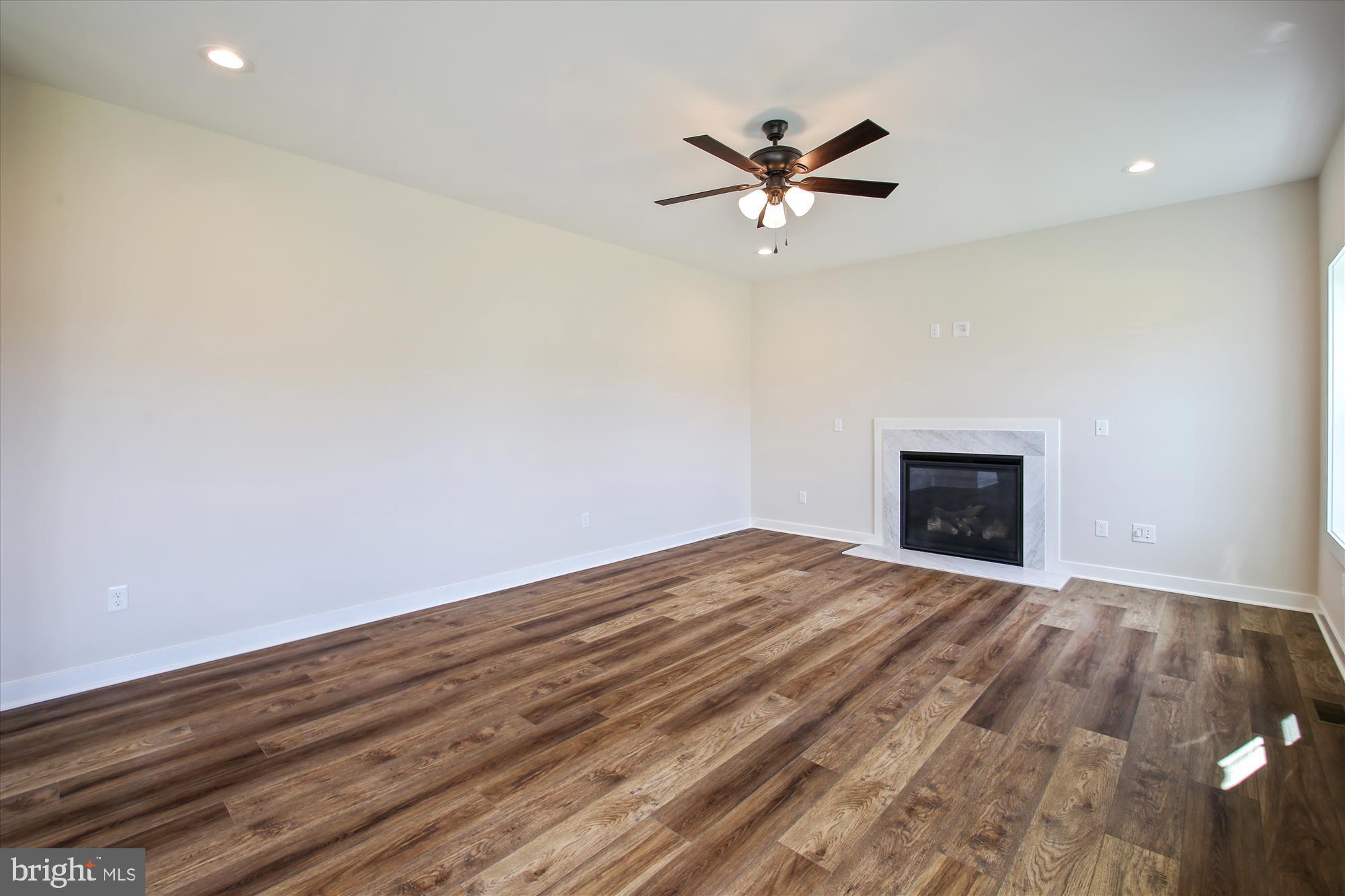 509 South Farm Crossing Road Severn, MD 21144 - Photo 12 of 35 a view of empty room with wooden floor and fireplace