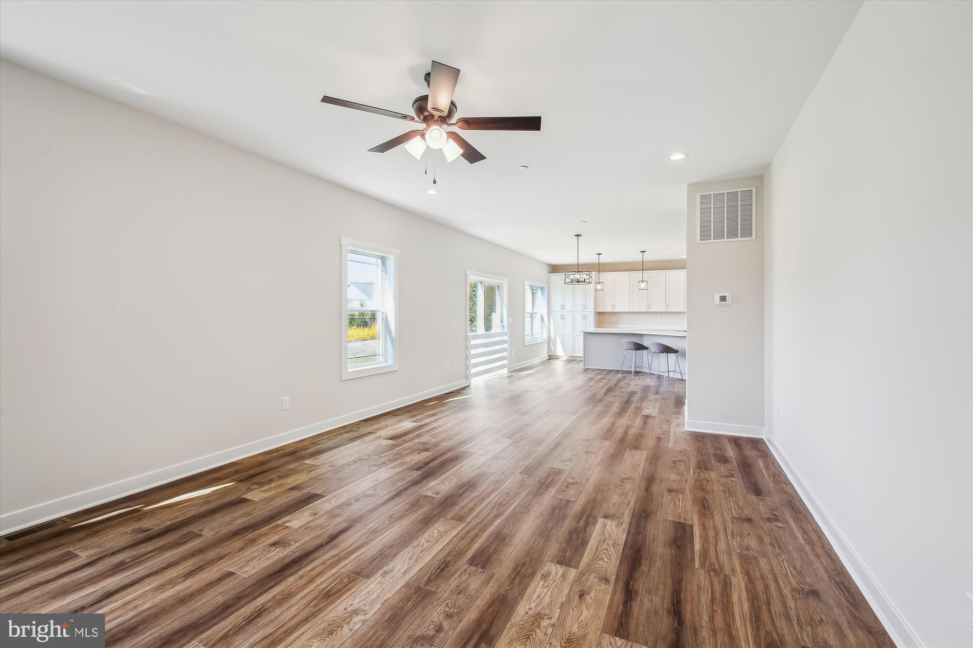 509 South Farm Crossing Road Severn, MD 21144 - Photo 14 of 35 a view of a room with wooden floor ceiling fan and window