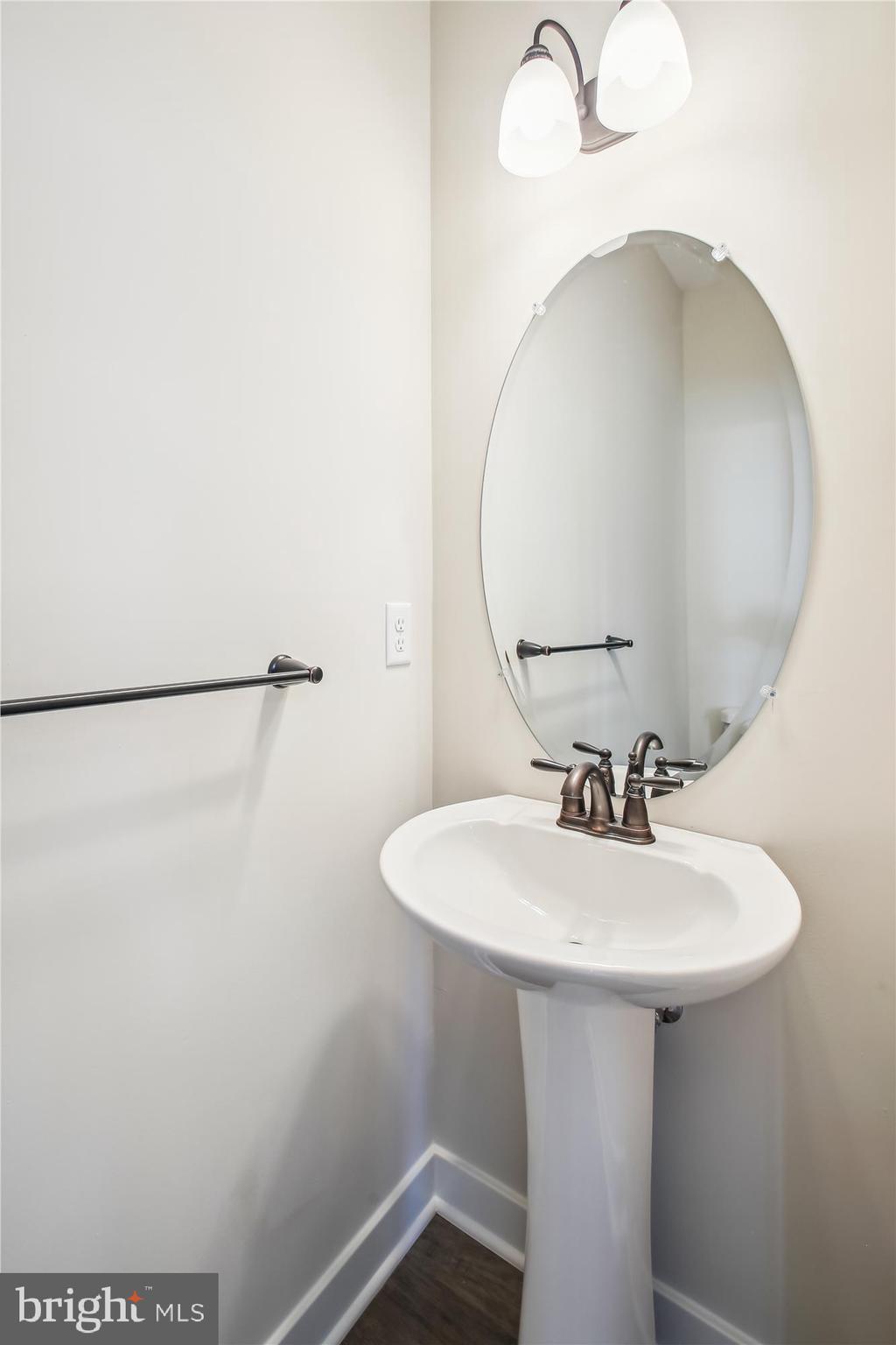 509 South Farm Crossing Road Severn, MD 21144 - Photo 18 of 35 a bathroom with a sink a mirror and shower