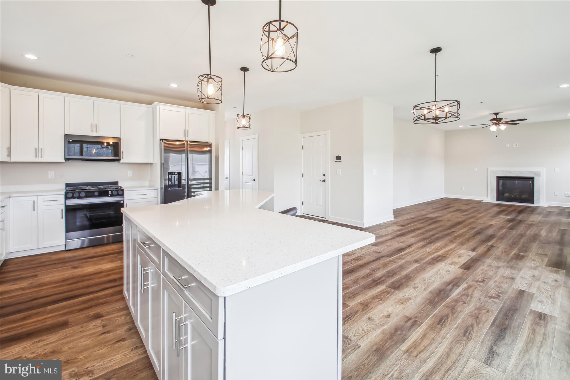 509 South Farm Crossing Road Severn, MD 21144 - Photo 3 of 35 a kitchen with kitchen island white cabinets and stainless steel appliances