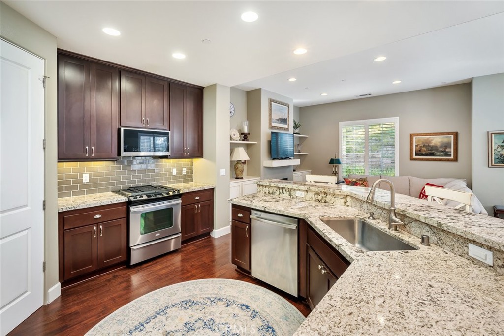 1187 Swallowtail Way Nipomo, CA 93444 - Photo 11 of 59 a large kitchen with stainless steel appliances granite countertop a sink stove and refrigerator
