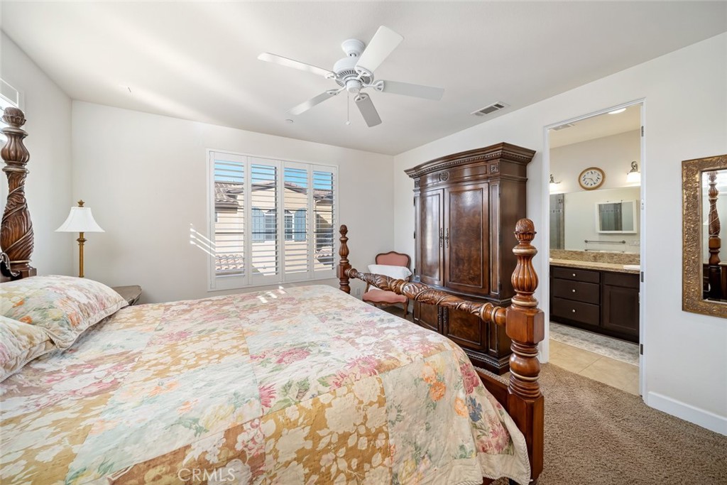 1187 Swallowtail Way Nipomo, CA 93444 - Photo 17 of 59 a bedroom with a bed dresser and wooden floor