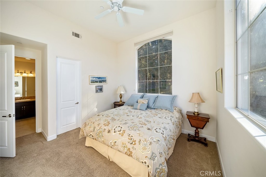 1187 Swallowtail Way Nipomo, CA 93444 - Photo 21 of 59 a bedroom with a bed and a chandelier