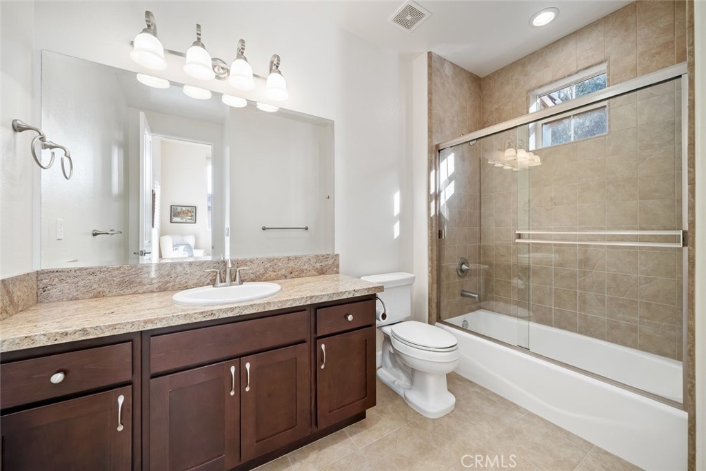 1187 Swallowtail Way Nipomo, CA 93444 - Photo 22 of 59 a bathroom with a granite countertop sink toilet and shower