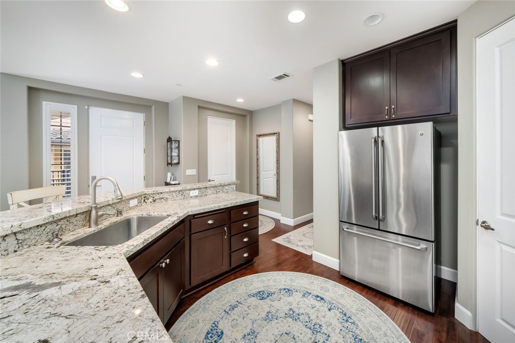 1187 Swallowtail Way Nipomo, CA 93444 - Photo 10 of 59 a kitchen with stainless steel appliances granite countertop a refrigerator a sink a stove and island