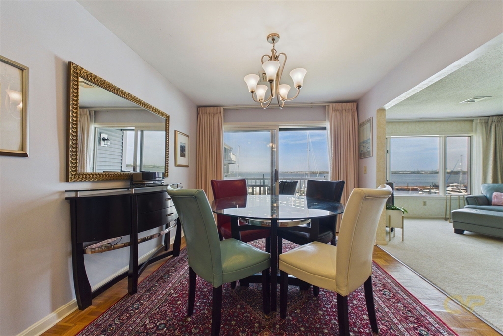 700 Shore Drive, Unit 509 Fall River, MA 02721 - Photo 9 of 25 a view of a dining room with furniture window and wooden floor