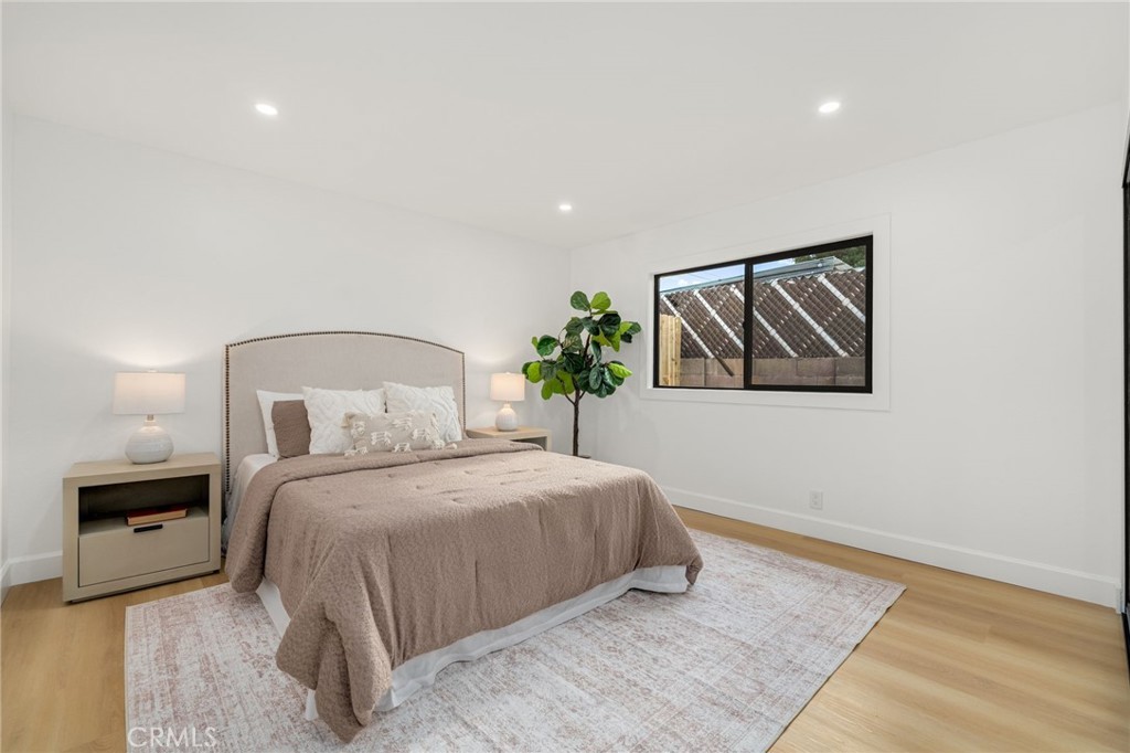 6072 Navajo Road Westminster, CA 92683 - Photo 18 of 26 a bedroom with a bed and a painting on the wall