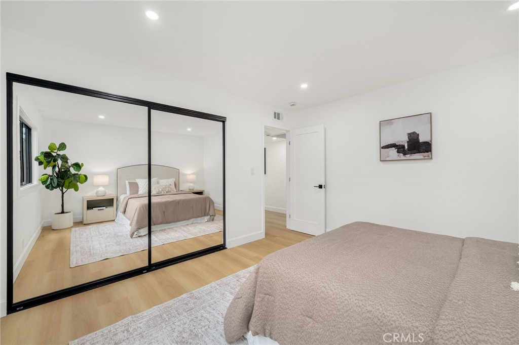 6072 Navajo Road Westminster, CA 92683 - Photo 19 of 26 a bedroom with a bed and a potted plant