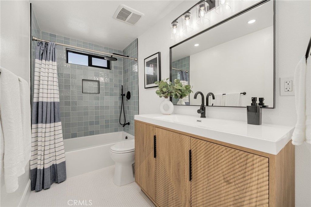6072 Navajo Road Westminster, CA 92683 - Photo 20 of 26 a bathroom with a sink a toilet and shower