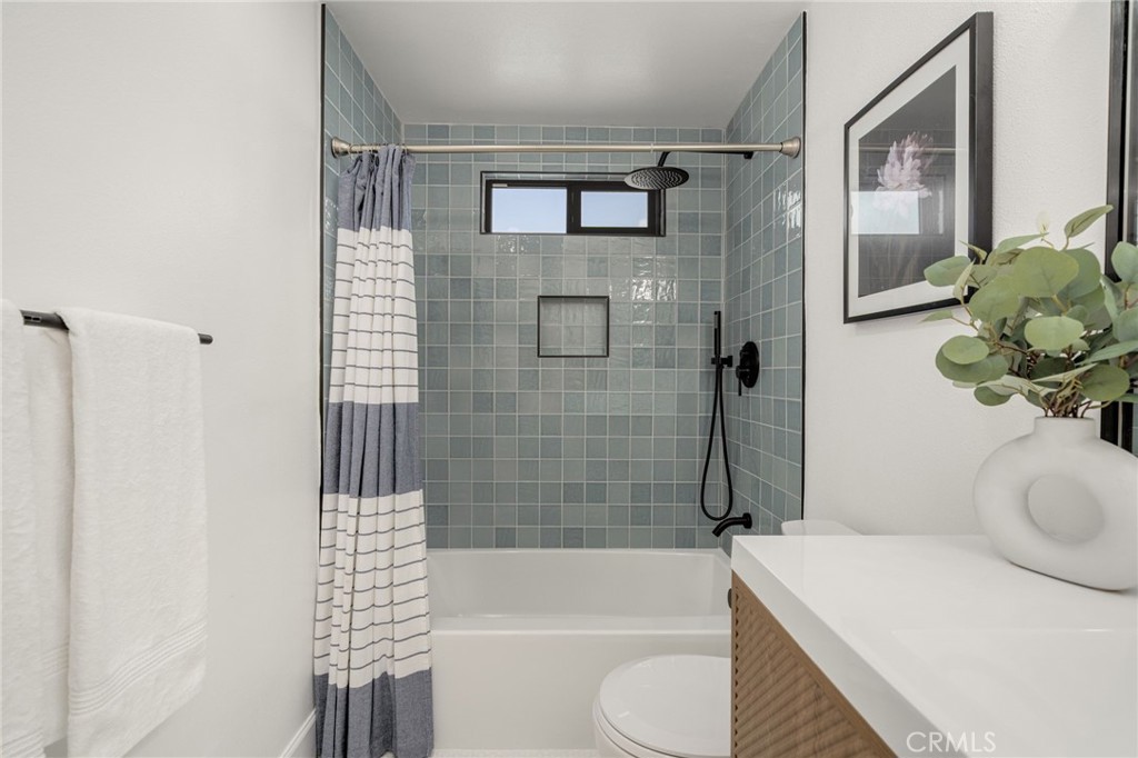 6072 Navajo Road Westminster, CA 92683 - Photo 21 of 26 a bathroom with a sink a toilet and shower