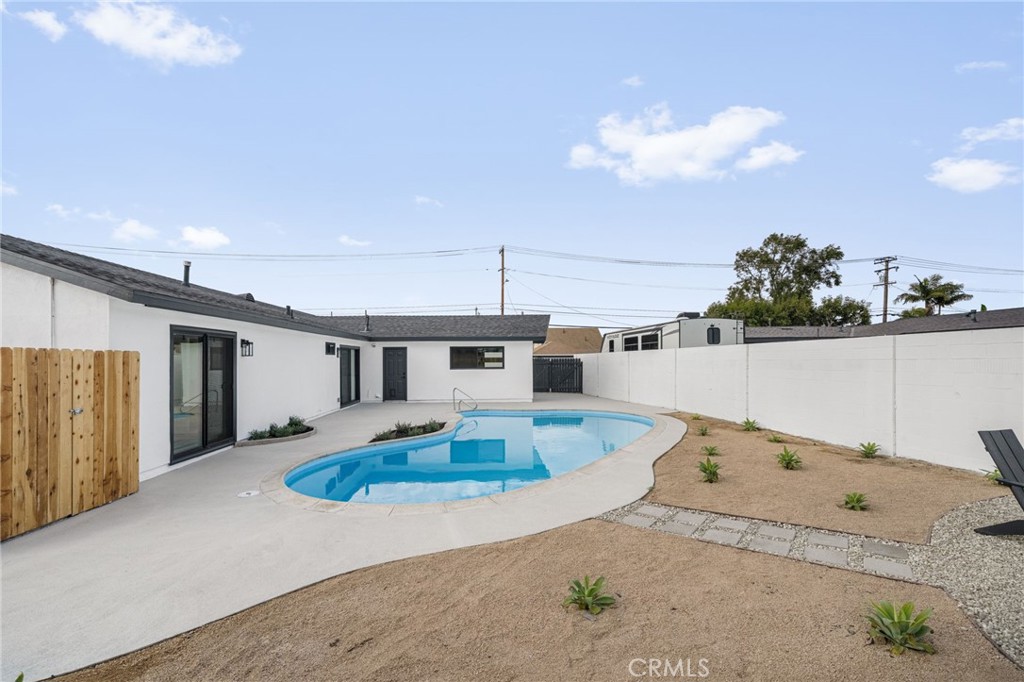 6072 Navajo Road Westminster, CA 92683 - Photo 23 of 26 a kitchen with kitchen island granite countertop cabinets and refrigerator