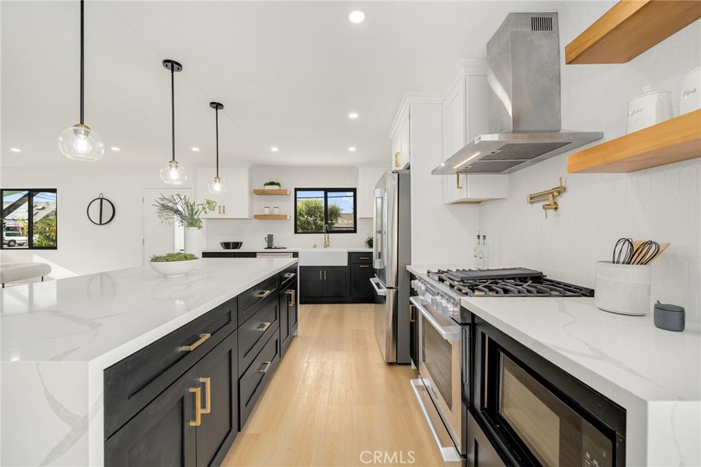 6072 Navajo Road Westminster, CA 92683 - Photo 7 of 26 a kitchen with a stove and a sink