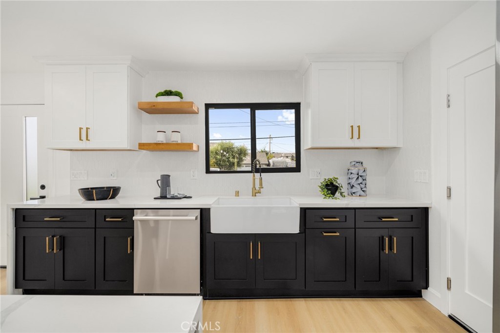6072 Navajo Road Westminster, CA 92683 - Photo 8 of 26 a kitchen with a sink a window and cabinets