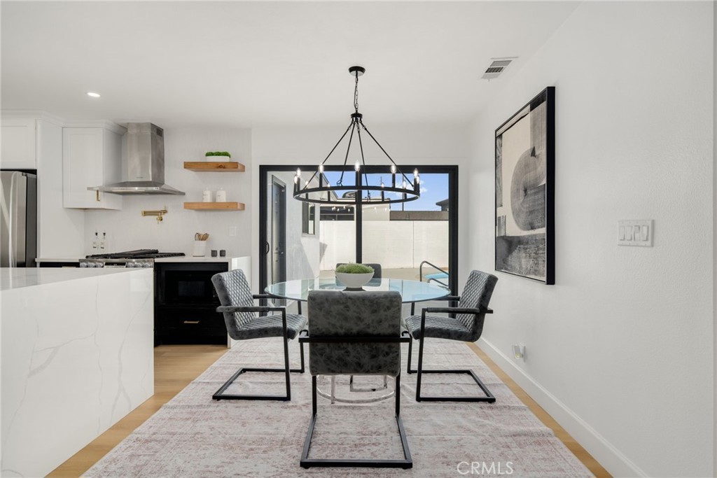 6072 Navajo Road Westminster, CA 92683 - Photo 9 of 26 a dining room with furniture and window