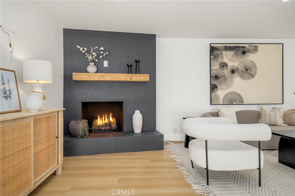 6072 Navajo Road Westminster, CA 92683 - Photo 10 of 26 a living room with furniture and a fireplace