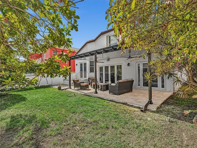 a view of a house with backyard porch and sitting area