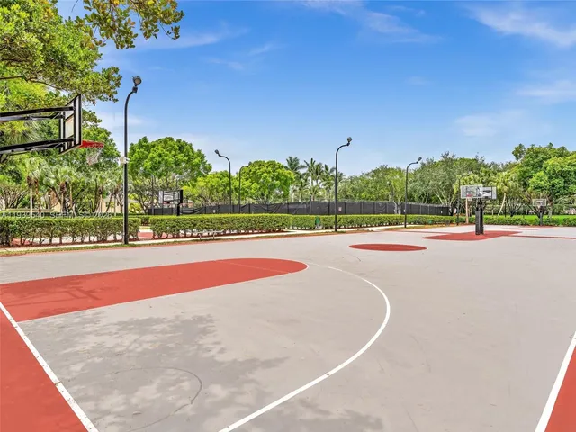 a living room with fireplace furniture and a large window