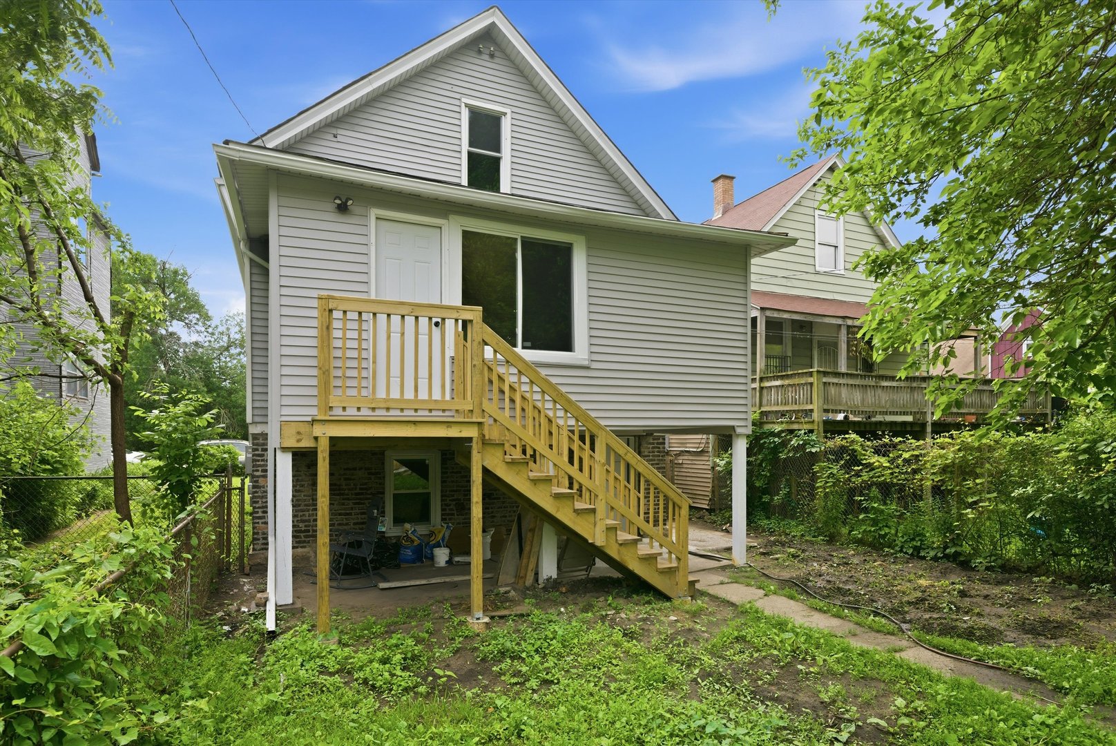7828 South Escanaba Avenue Chicago, IL 60649 - Photo 37 of 41 a front view of a house with a yard