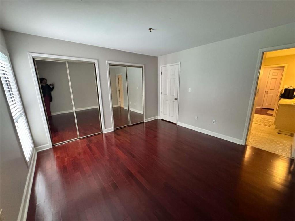 3201 Lenox Road Northeast, Unit 2 Atlanta, GA 30324 - Photo 12 of 39 a view of an empty room with wooden floor and a window