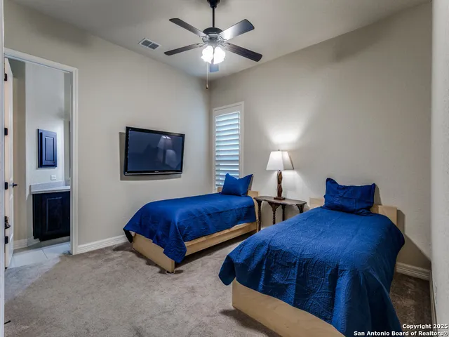 a bedroom with two beds and a lamp