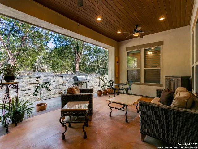 a living room with patio furniture and a large window