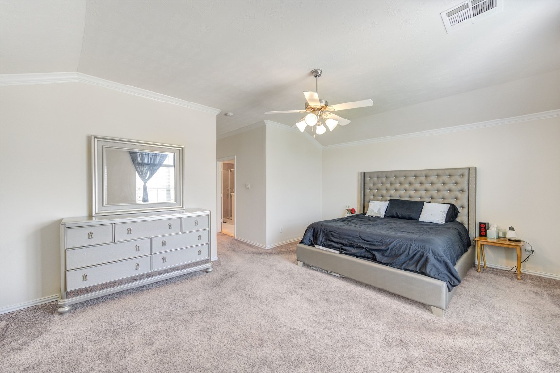 5103 Dartmoor Ridge Trail Houston, TX 77066 - Photo 20 of 47 a spacious bedroom with a bed and a chandelier