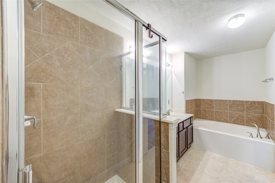 5103 Dartmoor Ridge Trail Houston, TX 77066 - Photo 24 of 47 Master bathroom offers a glass enclosed shower and a separated garden tub