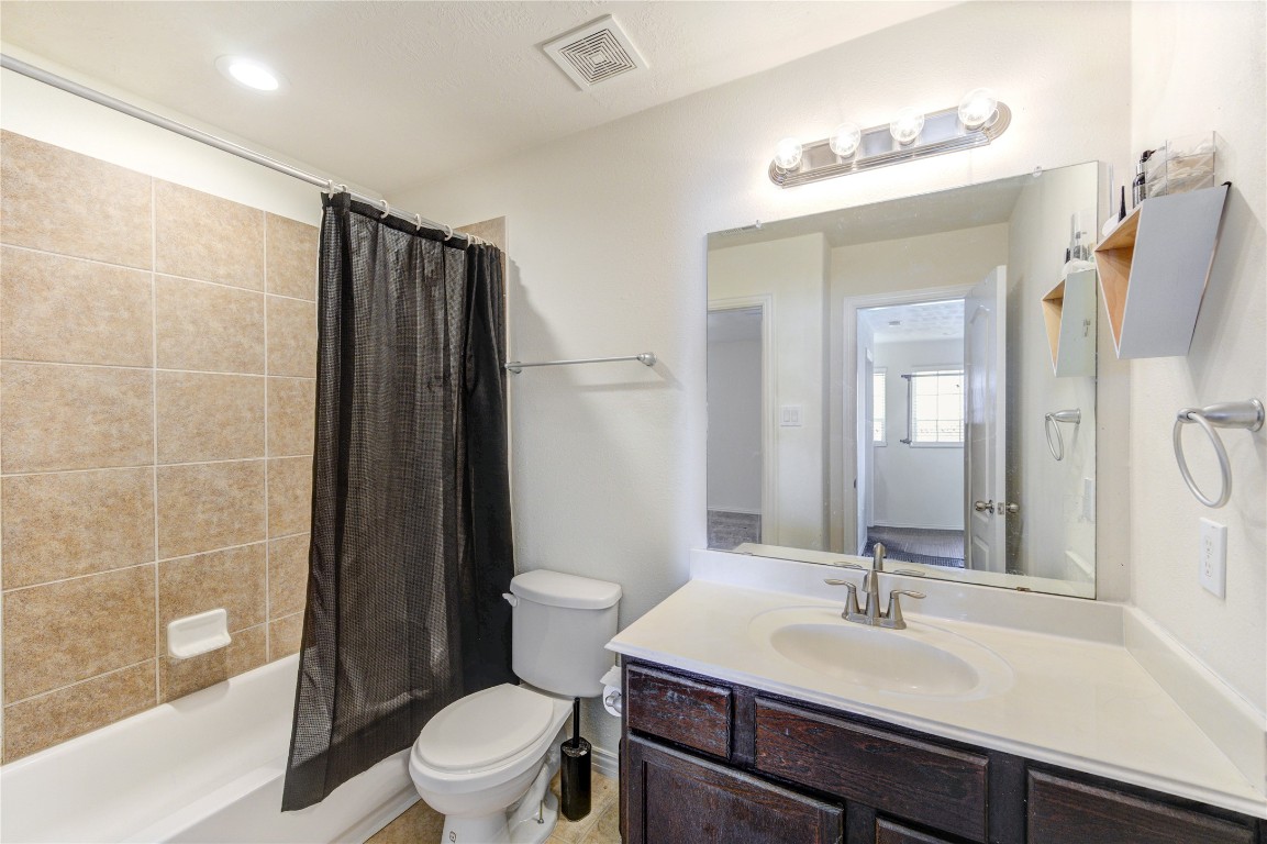 5103 Dartmoor Ridge Trail Houston, TX 77066 - Photo 29 of 47 a bathroom with a sink toilet vanity and shower