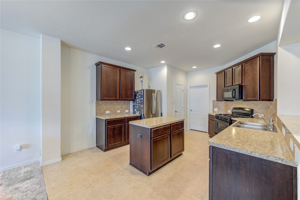 5103 Dartmoor Ridge Trail Houston, TX 77066 - Photo 5 of 47 a kitchen with stainless steel appliances granite countertop a stove oven and a refrigerator
