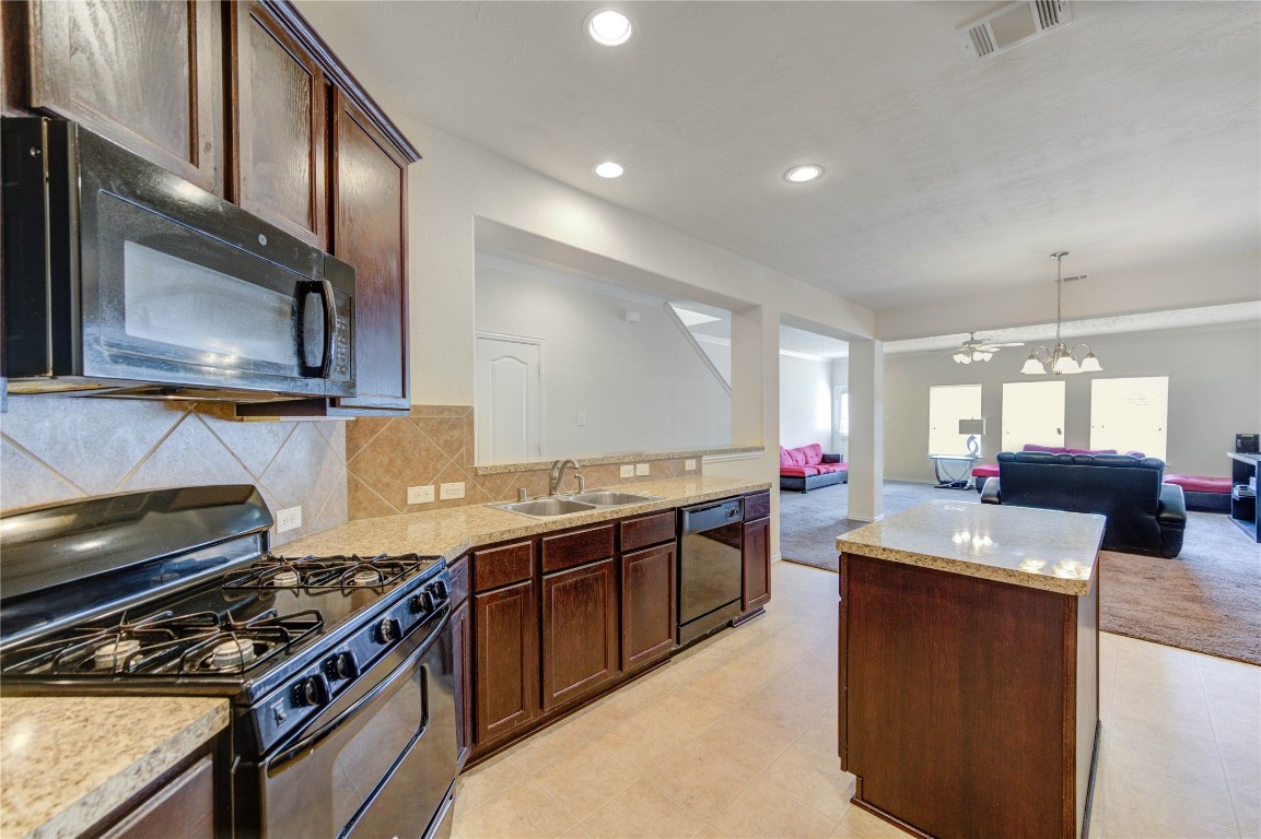 5103 Dartmoor Ridge Trail Houston, TX 77066 - Photo 6 of 47 a kitchen with stainless steel appliances granite countertop a sink stove and refrigerator