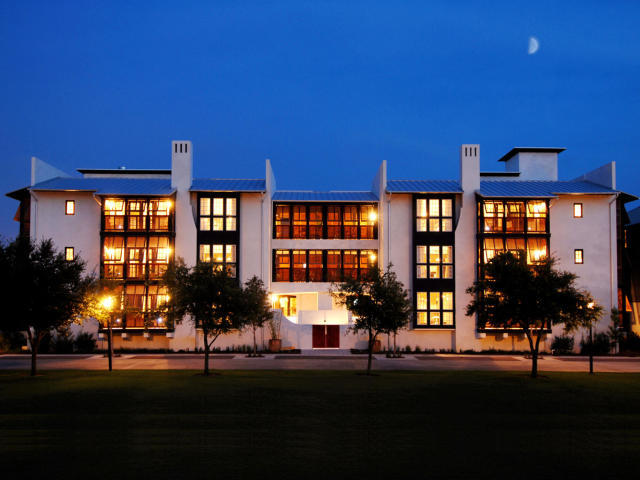 a front view of building with yard and green space