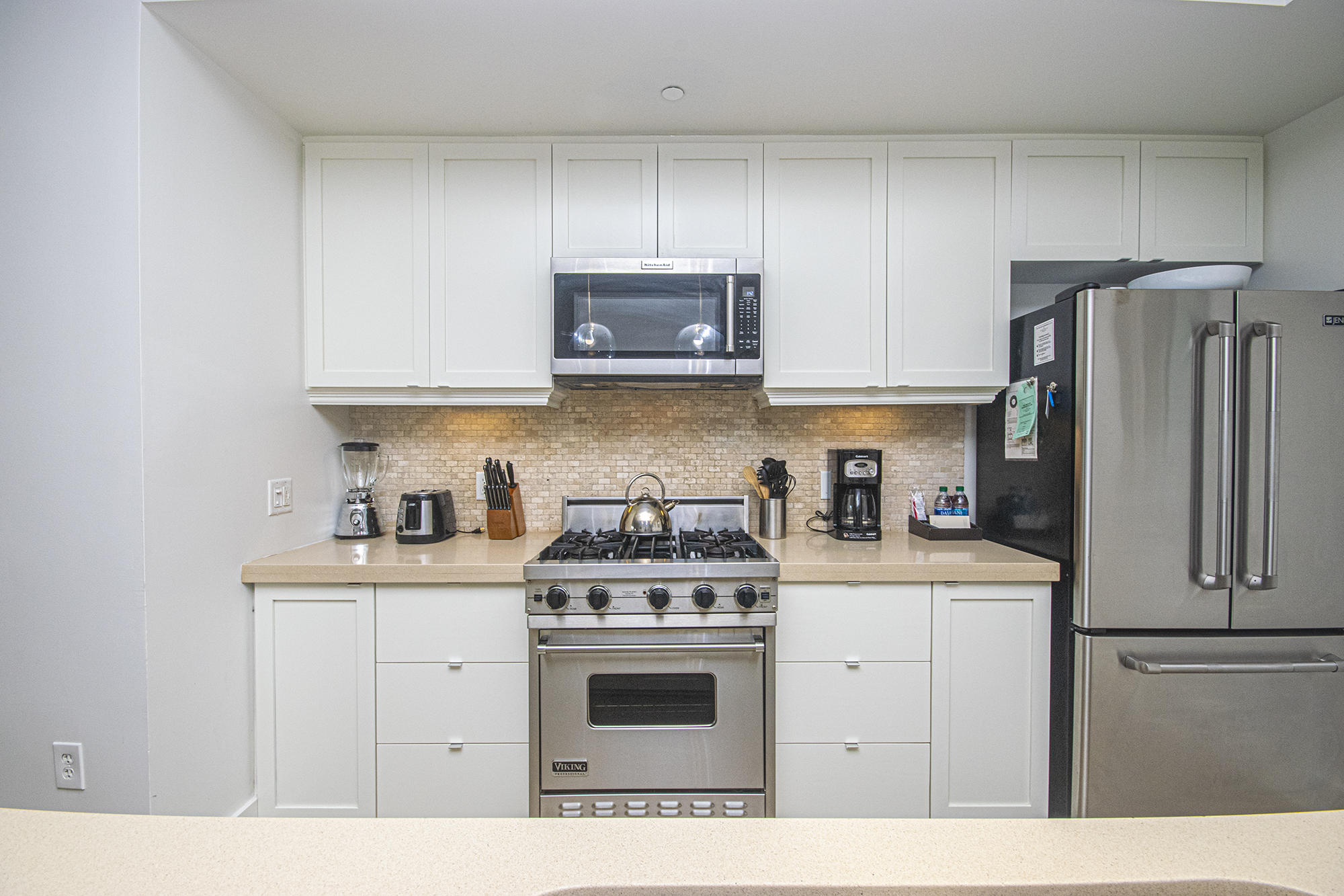 136 Georgetown Avenue, Unit 2E1 Rosemary Beach, FL 32461 - Photo 22 of 49 a kitchen with stainless steel appliances granite countertop a stove a refrigerator a sink dishwasher and white cabinets