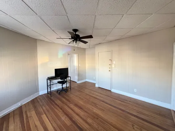 a view of workspace with wooden floor and a ceiling fan