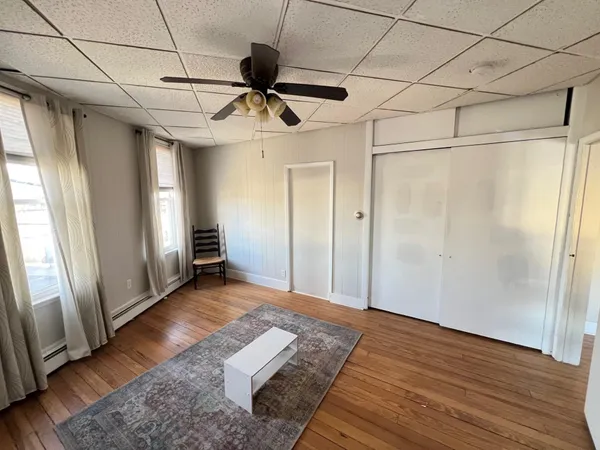 a view of empty room with wooden floor