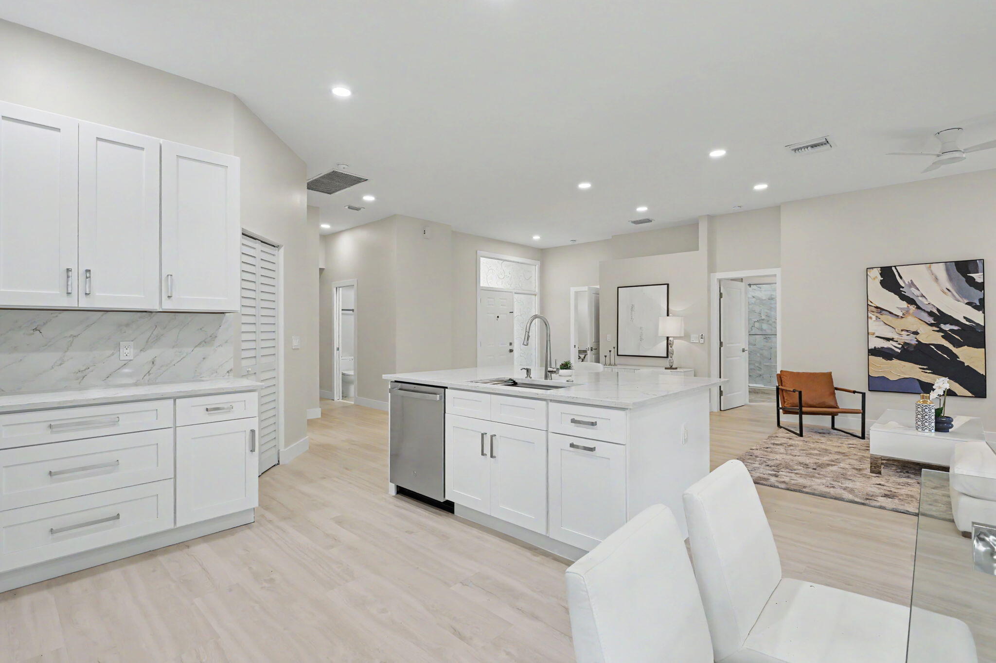 7832 Rockford Road Boynton Beach, FL 33472 - Photo 12 of 40 a large kitchen with kitchen island a sink white cabinets and stainless steel appliances