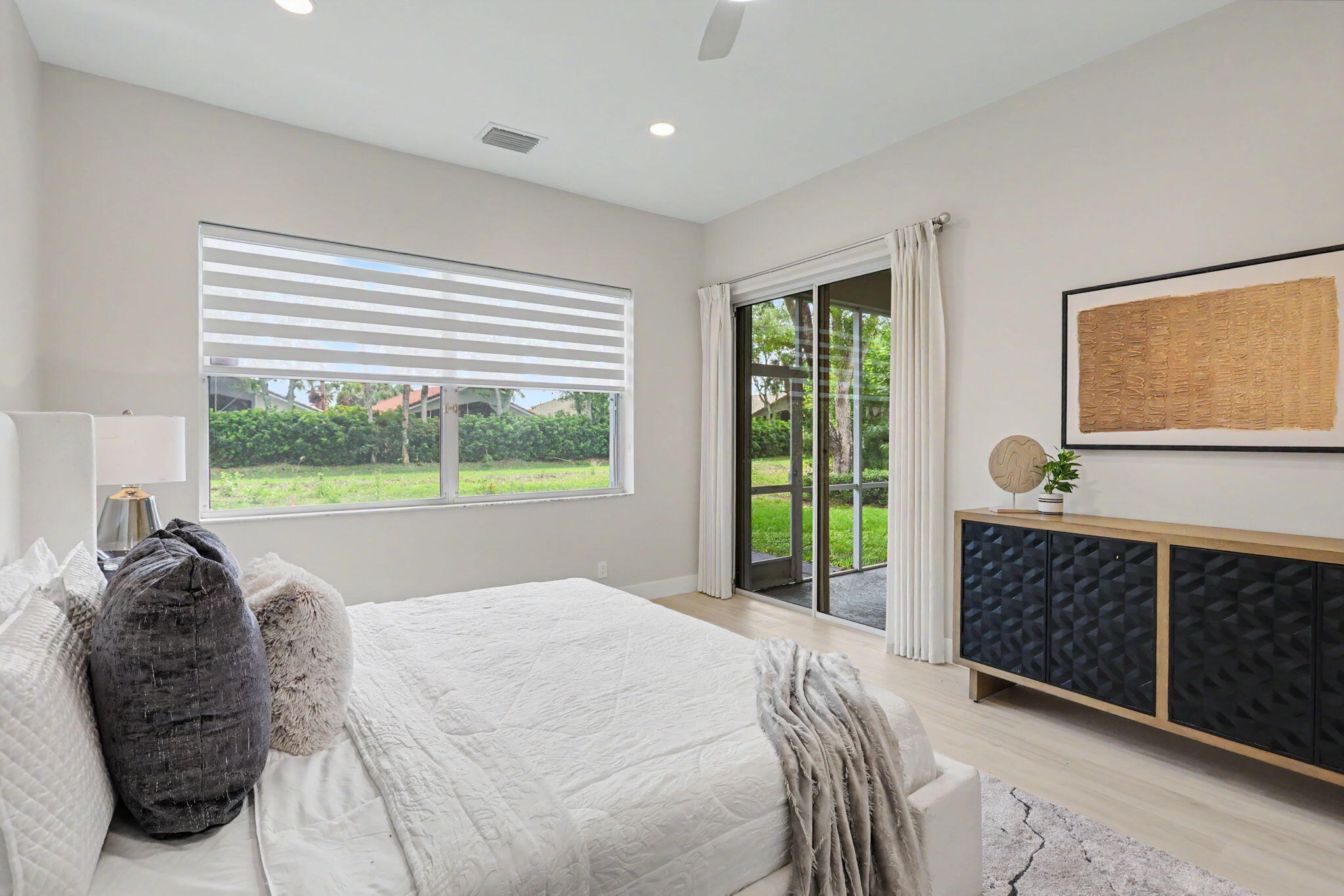 7832 Rockford Road Boynton Beach, FL 33472 - Photo 17 of 40 a bed sitting in a bedroom next to a window