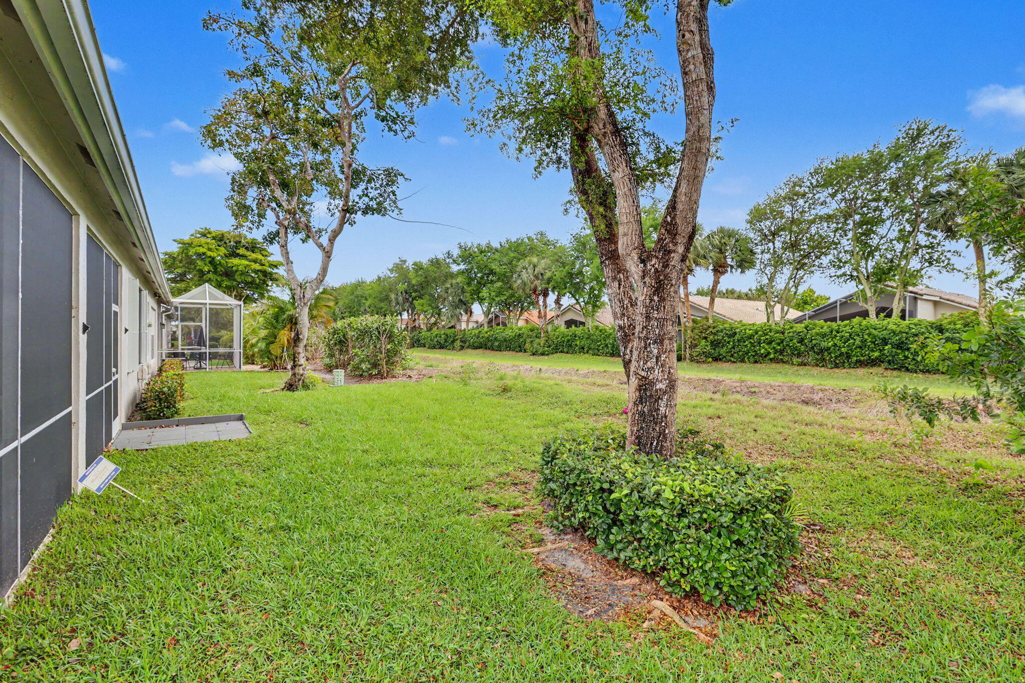 7832 Rockford Road Boynton Beach, FL 33472 - Photo 32 of 40 a view of a garden with a tree