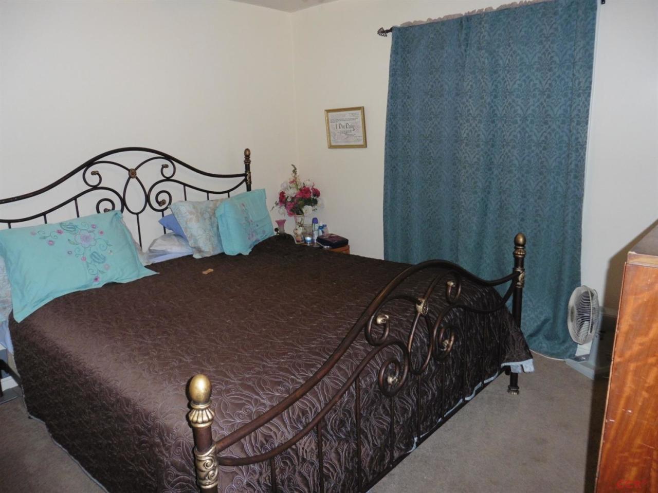 3956 Constellation Road Lompoc, CA 93436 - Photo 11 of 17 a bedroom with a bed and a small bathroom