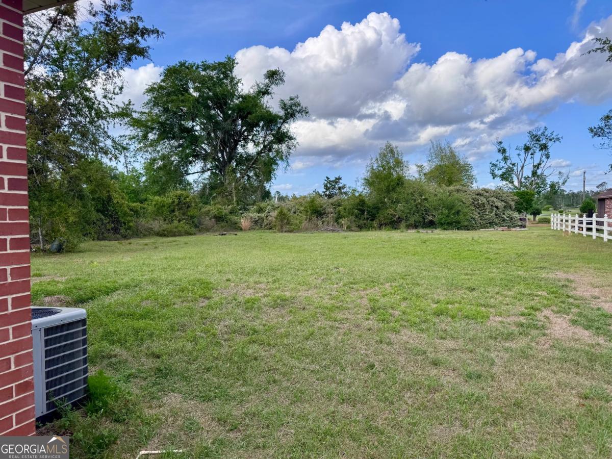 15 Dogwood Road Hazlehurst, GA 31539 - Photo 15 of 16 a view of a garden with a building in the background