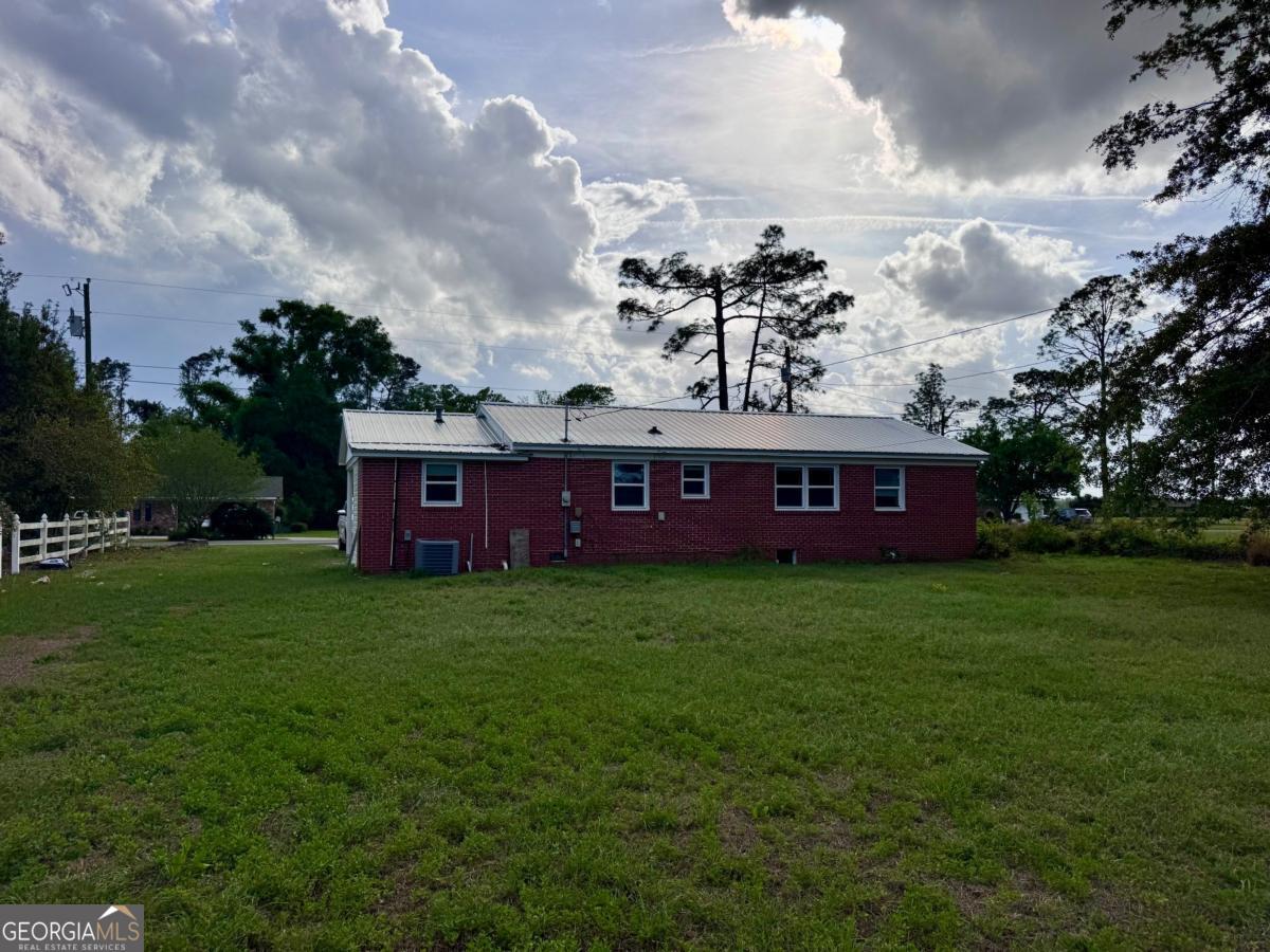 15 Dogwood Road Hazlehurst, GA 31539 - Photo 16 of 16 a view of a big yard with a house in the background
