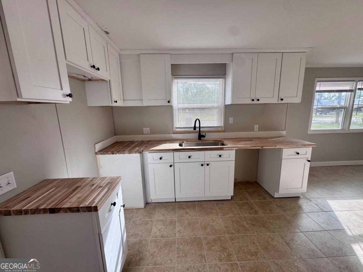 15 Dogwood Road Hazlehurst, GA 31539 - Photo 3 of 16 a kitchen with stainless steel appliances granite countertop a sink stove top oven and cabinets