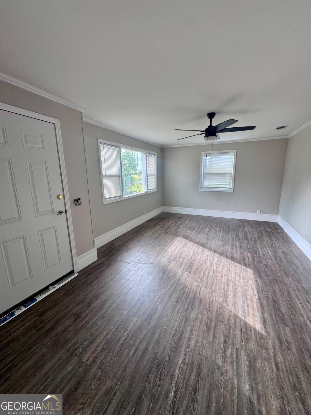 15 Dogwood Road Hazlehurst, GA 31539 - Photo 4 of 16 wooden floor in an empty room with a window
