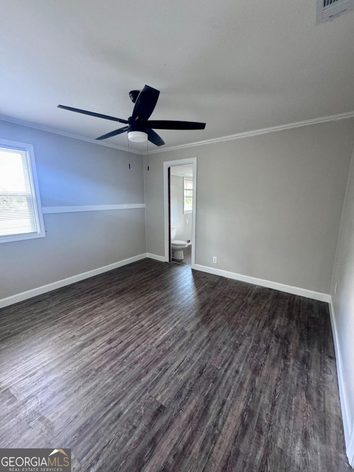 15 Dogwood Road Hazlehurst, GA 31539 - Photo 7 of 16 wooden floor in an empty room with a window