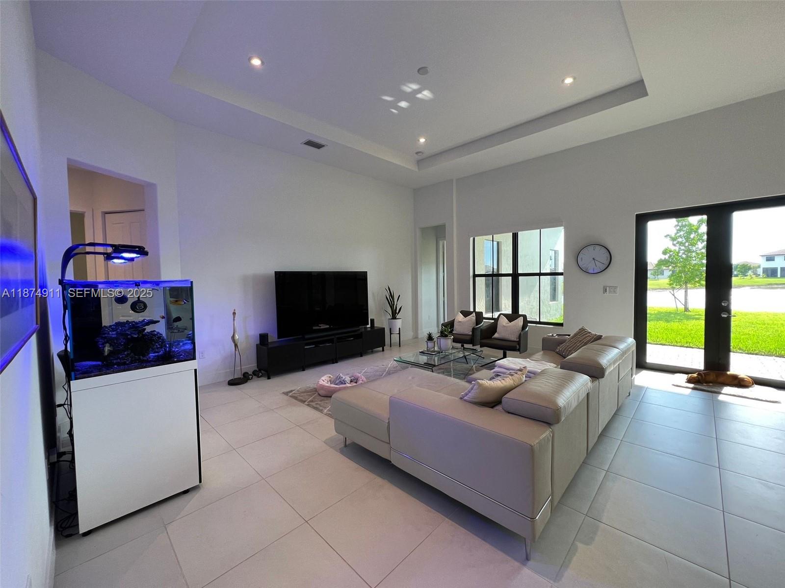 Maple Ridge Ave Maria, FL 34142 - Photo 4 of 4 a living room with furniture and a flat screen tv