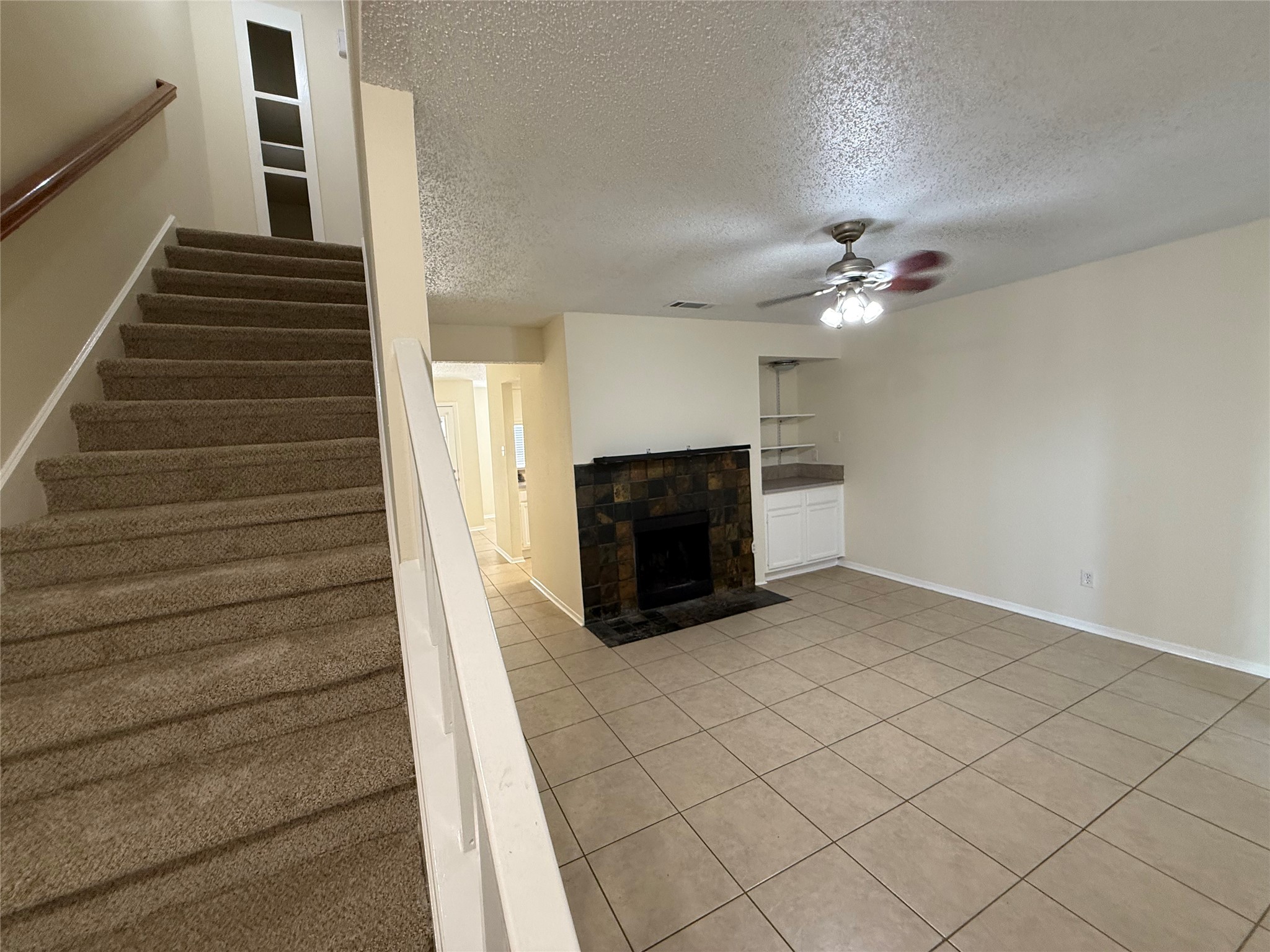 3837 Tanglewilde Street, Unit 3837 Houston, TX 77063 - Photo 1 of 12 a view of a livingroom with an empty space and a fireplace