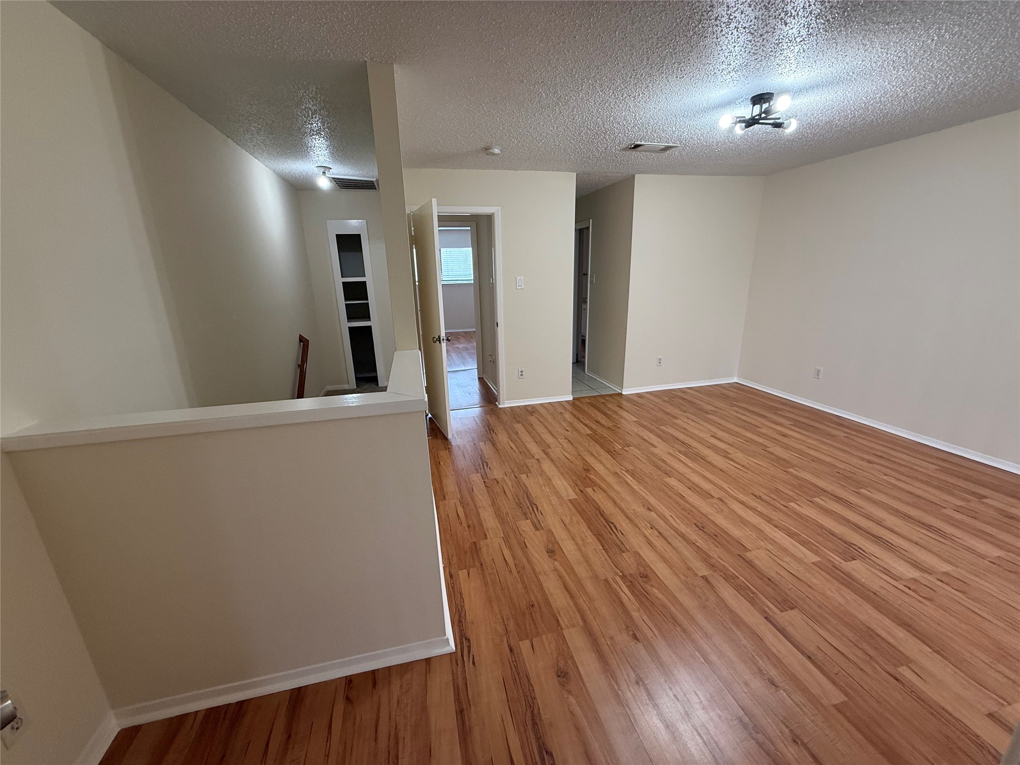 3837 Tanglewilde Street, Unit 3837 Houston, TX 77063 - Photo 5 of 12 a view of a hallway with wooden floor