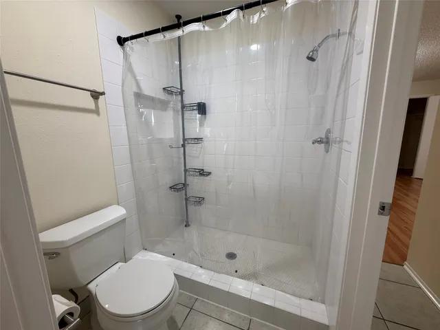 a white toilet sitting next to a bathroom